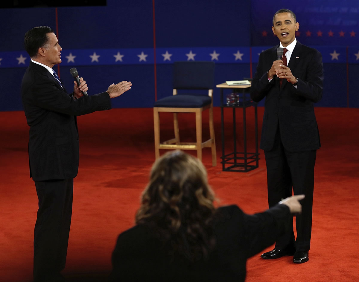 Republican presidential nominee Mitt Romney and and President Barack Obama answer a question during the second presidential debate at Hofstra University on Tuesday in Hempstead, N.Y.