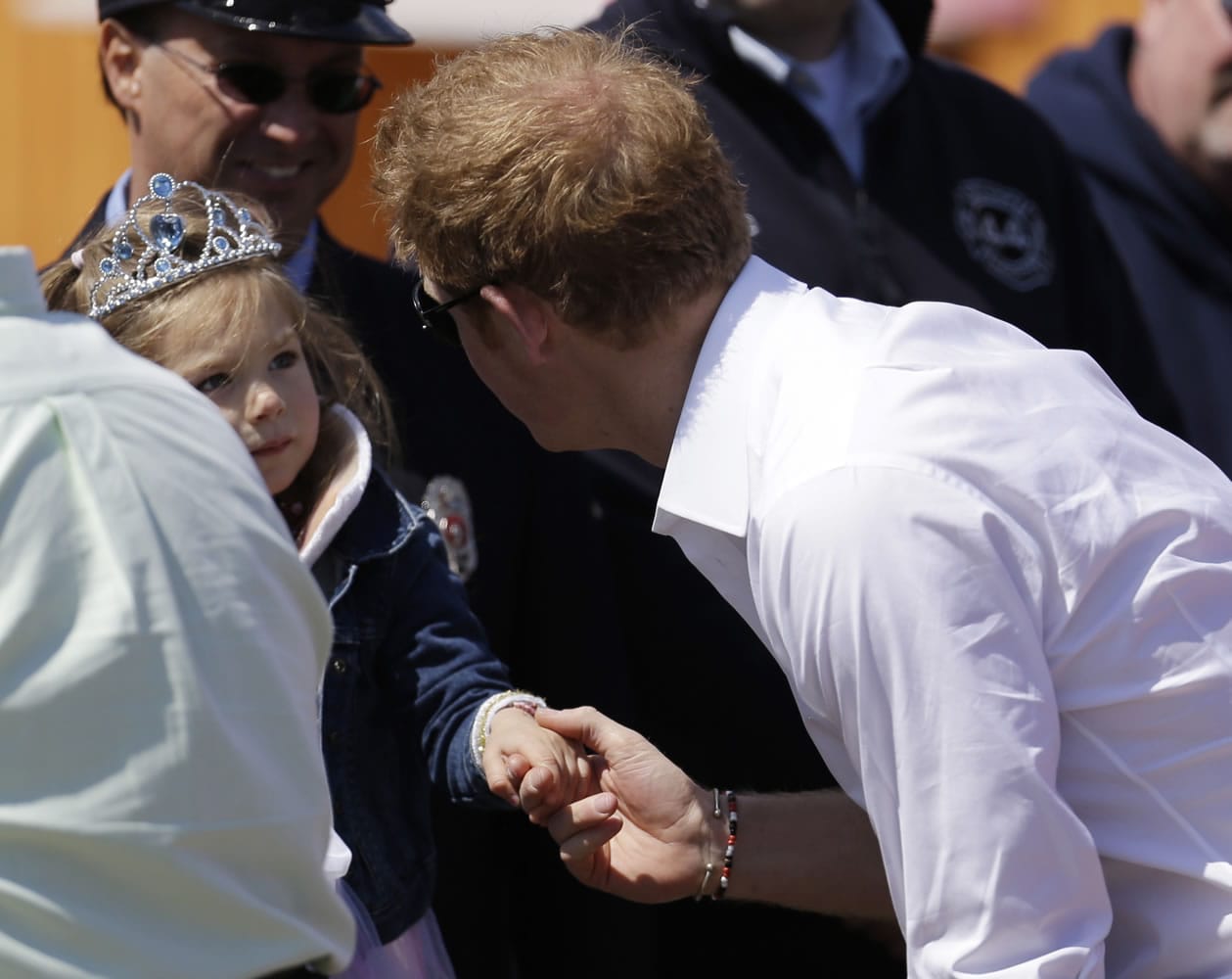 Britain's Prince Harry, right, talks to a young girl at Casino Pier during a tour of the area hit by Superstorm Sandy on Tuesday in Seaside Heights, N.J. The prince toured the community's rebuilt boardwalk, which is about two-thirds complete.