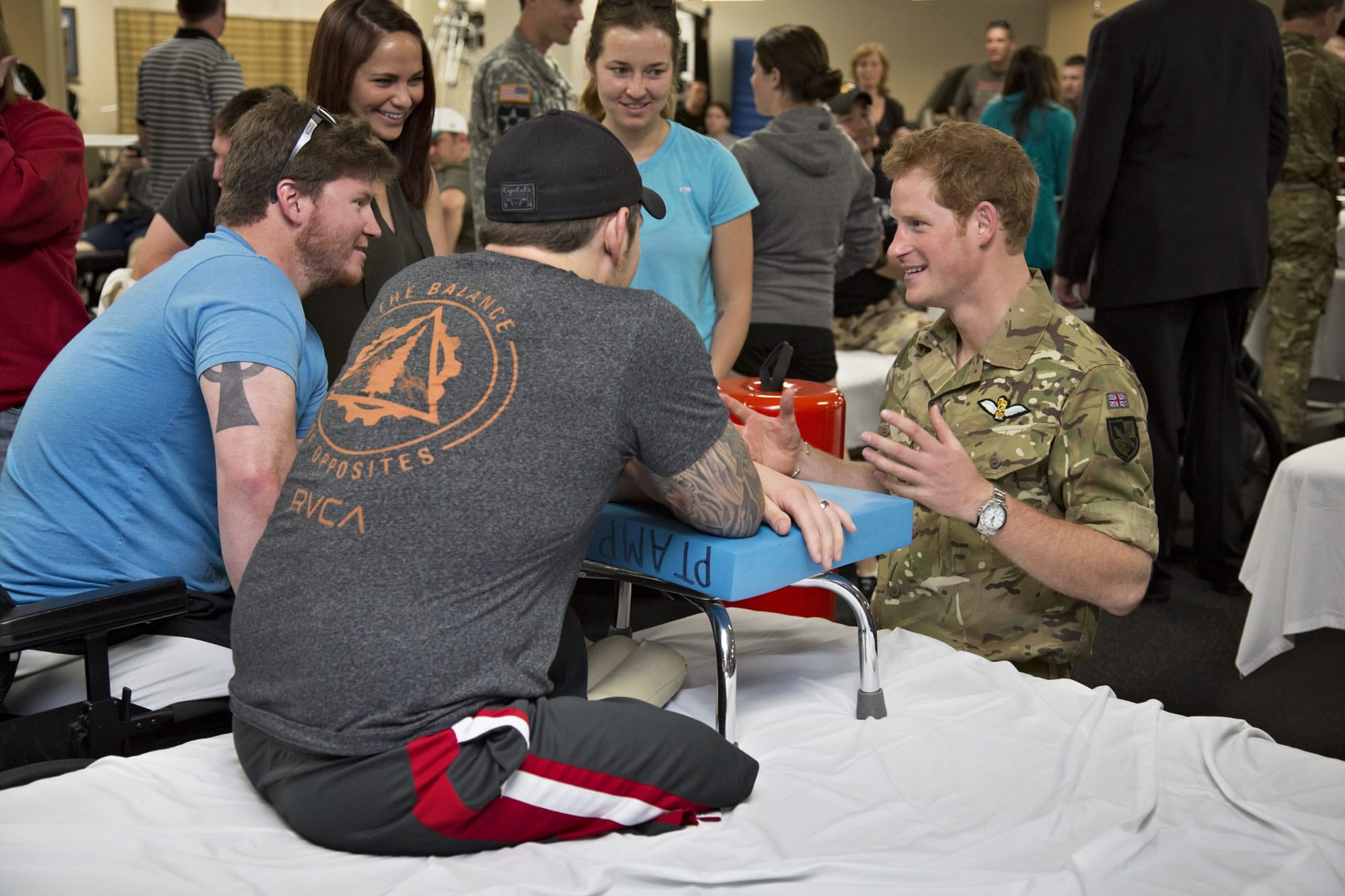 Wearing his British Army uniform, Britain's Prince Harry visits Friday with wounded warriors undergoing physical therapy at the Military Advanced Training Center at Walter Reed National Military Medical Center in Bethesda, Md., just outside Washington.