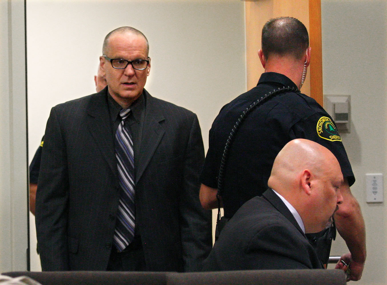 Byron Scherf, left, is escorted into a Snohomish County courtroom in Everett for his murder trial on May 1.