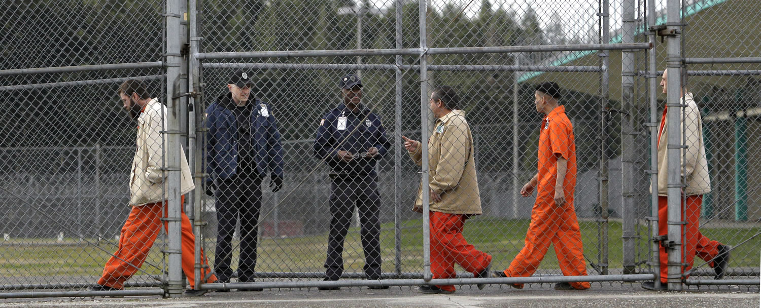 Inmates walk past correctional officers at the Washington Corrections Center in Shelton in 2011. Gov. Jay Inslee said Tuesday, Dec. 22, 2015 that more than 3,000 prisoners in Washington have been mistakenly released early since 2002 because of an error by the state's Department of Corrections.