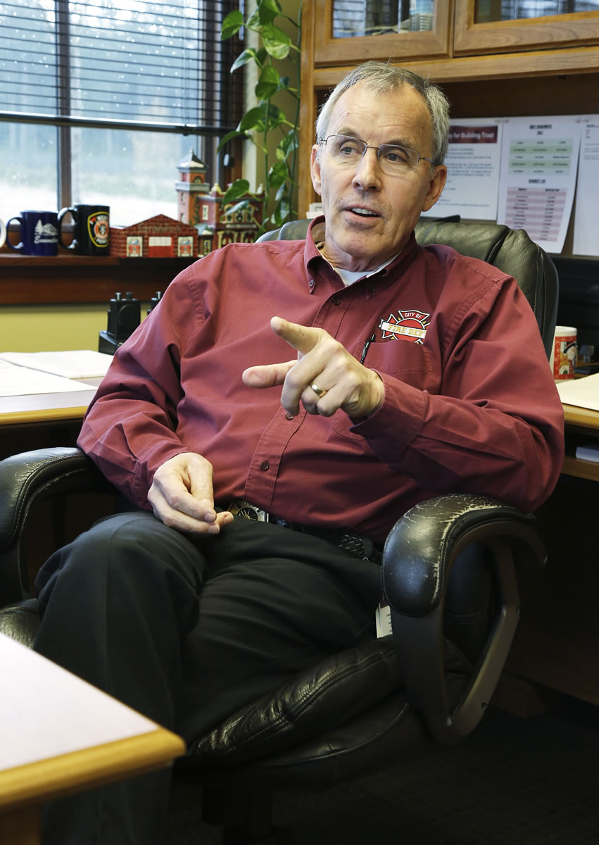 In this March 20, 2013 photo, Greg Hull speaks during an interview as he sits in his office in the fire department of DuPont, Wash. Hull received a substantial pay raise just before he retired as a manager with Lakewood Fire District No. 2, which increased his annual pension to $184,000. He currently works as fire chief in DuPont, but was hired as a icontractori in a way that doesnit disrupt his retirement payments. (AP Photo/Ted S.