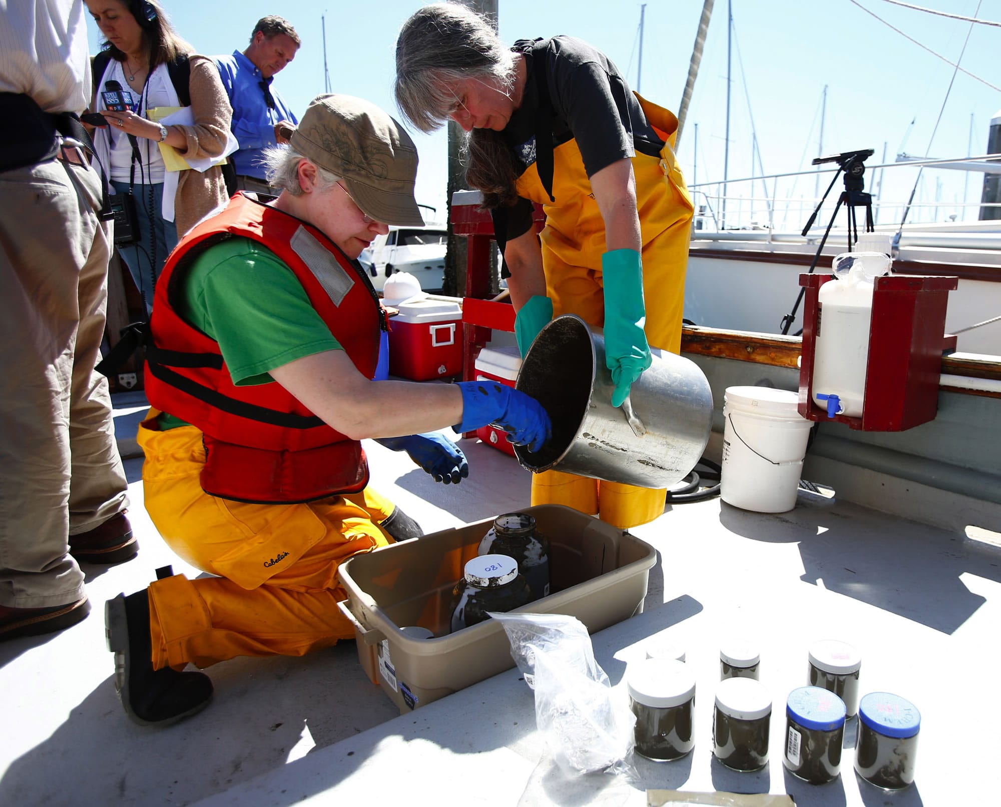 Valerie Partridge, right, and Maggie Dutch, left, both with the State Department of Ecology, store sediment samples from Elliott Bay for studying on Tuesday in Seattle.