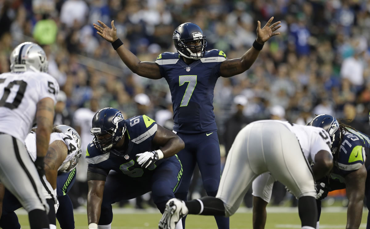 Seattle Seahawks quarterback Tarvaris Jackson (7) signals to his team from the line of scrimmage in the first half of an NFL preseason football game against the Oakland Raiders, Thursday, Aug. 29, 2013, in Seattle.