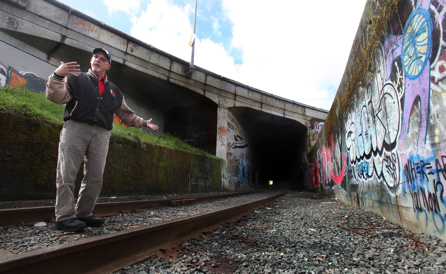 Tacoma Rail conductor Max Chabo stands Tuesday near the entrance to the tunnel at 8th and Cherry Street in Olympia. Chabo dragged a homeless man off the train tracks inside the tunnel last year.