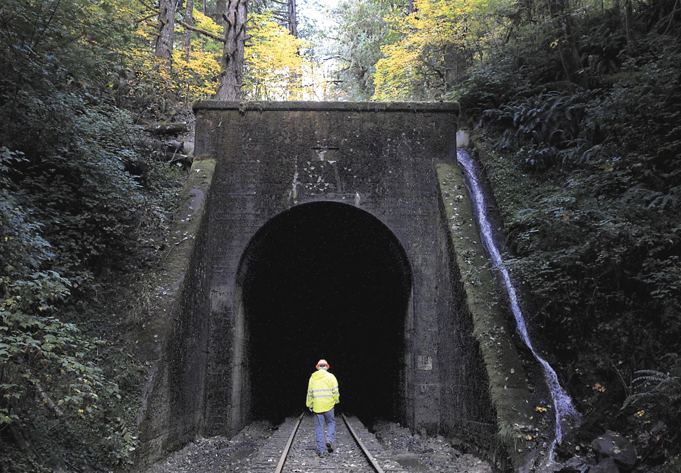 Tom Bishop, manager of Coos Bay Rail Link, walks through Tunnel 13, where workers were welding along the line near Noti, Ore., on  Oct.