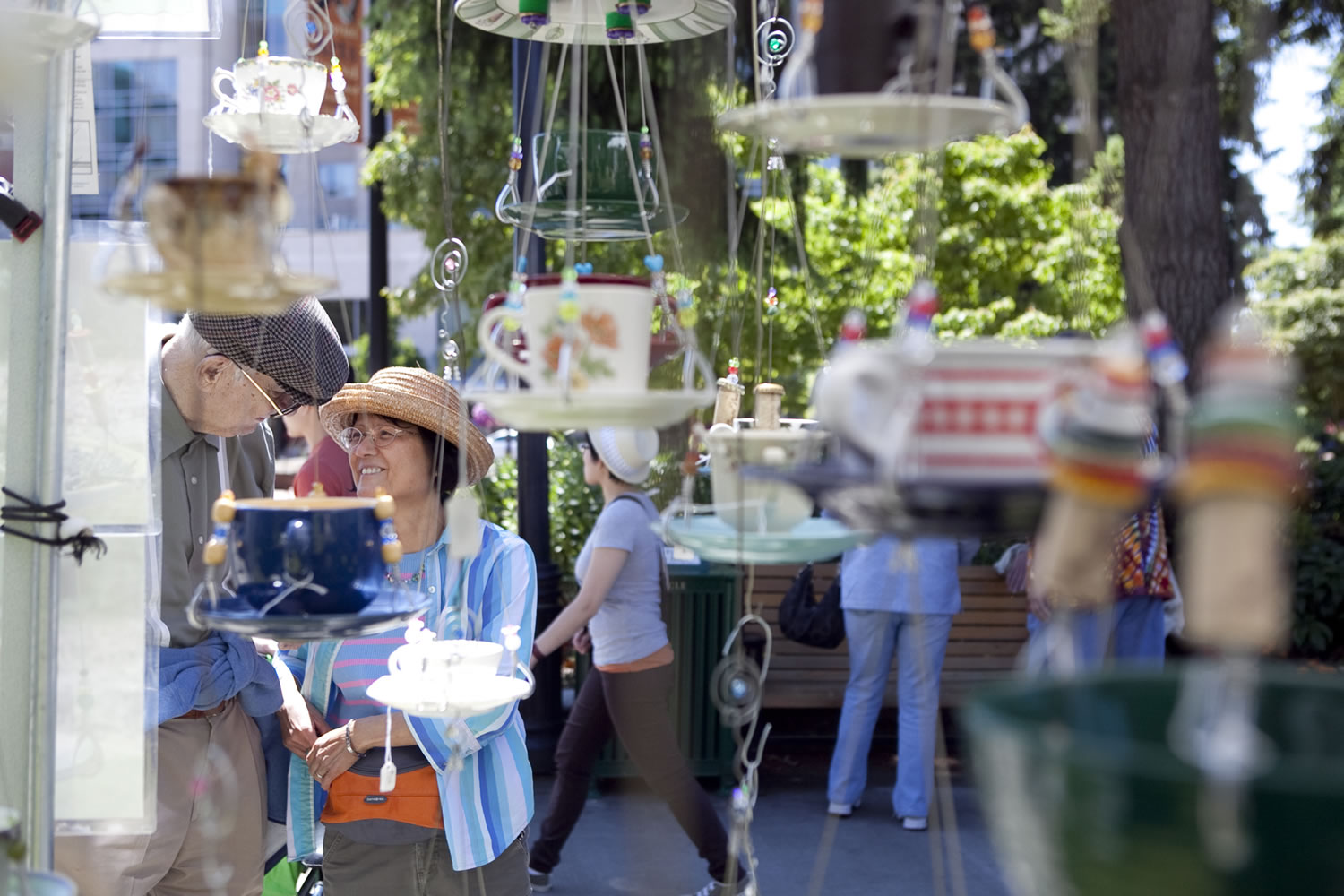 Mikiko Flynn and her husband, Tom, look at recycled bird feeders at last year's Recycled Arts Festival, a celebration of art created from recycled materials.