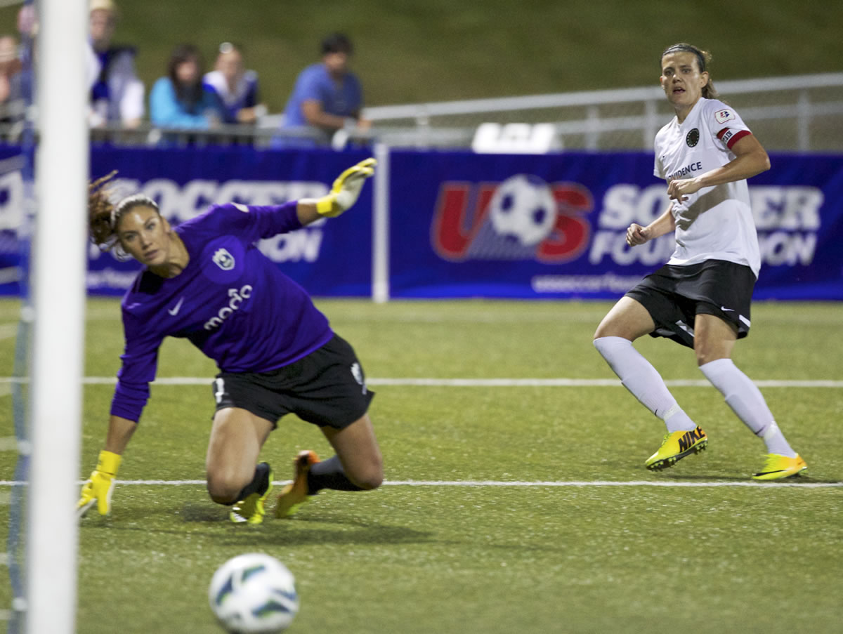 The Portland Thorns' Christine Sinclair watches her winning shot drive past the Seattle Reign's goalkeeper Hope Solo as the Thorns won their final match of the regular season, 2-1 Saturday in Tukwila.