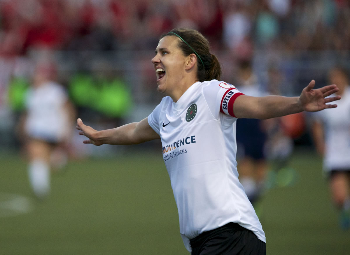 The Portland Thorns' Christine Sinclair (12) celebrates her first-half score in play against the Seattle Reign in their final match of the regular season in women's soccer match Saturday in Tukwila.