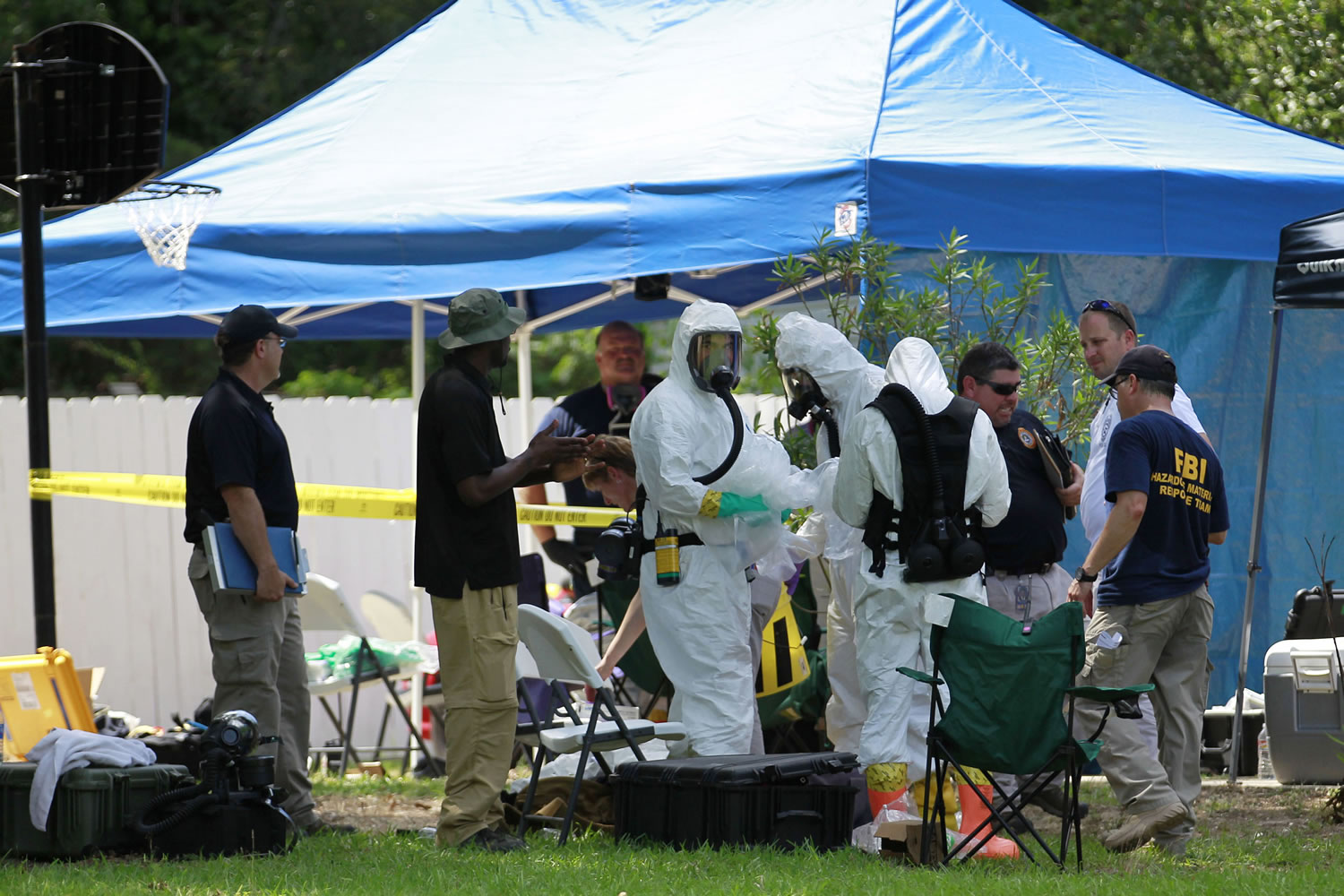 Members of an FBI hazardous materials team prepare to enter a residence in New Boston, Texas on May 31 in connection with a federal investigation surrounding ricin-laced letters mailed to President Barack Obama and New York Mayor Michael Bloomberg. Two U.S.