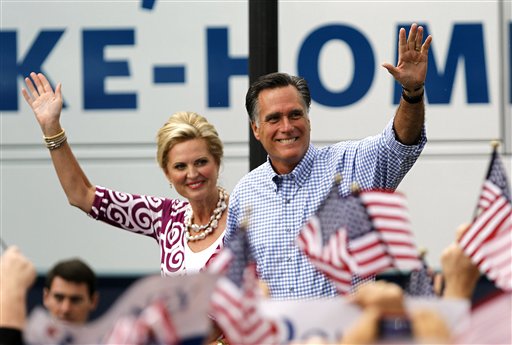 Republican presidential candidate and former Massachusetts Gov. Mitt Romney, right, waves as he arrives with his wife Ann at a campaign rally, Sunday, Oct. 7, 2012, in Port St. Lucie, Fla.