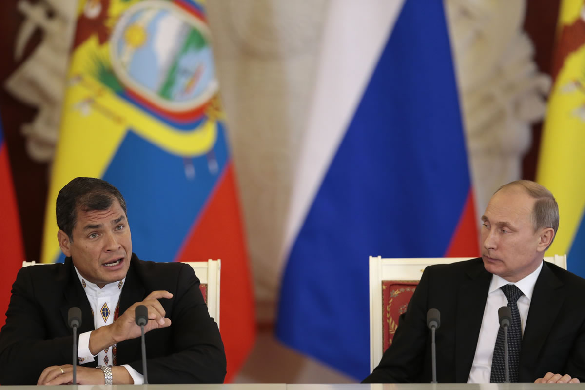 Russian President Vladimir Putin, right, listens to his Ecuadorian counterpart Rafael Correa in Moscow's Kremlin, Russia, on Tuesday.