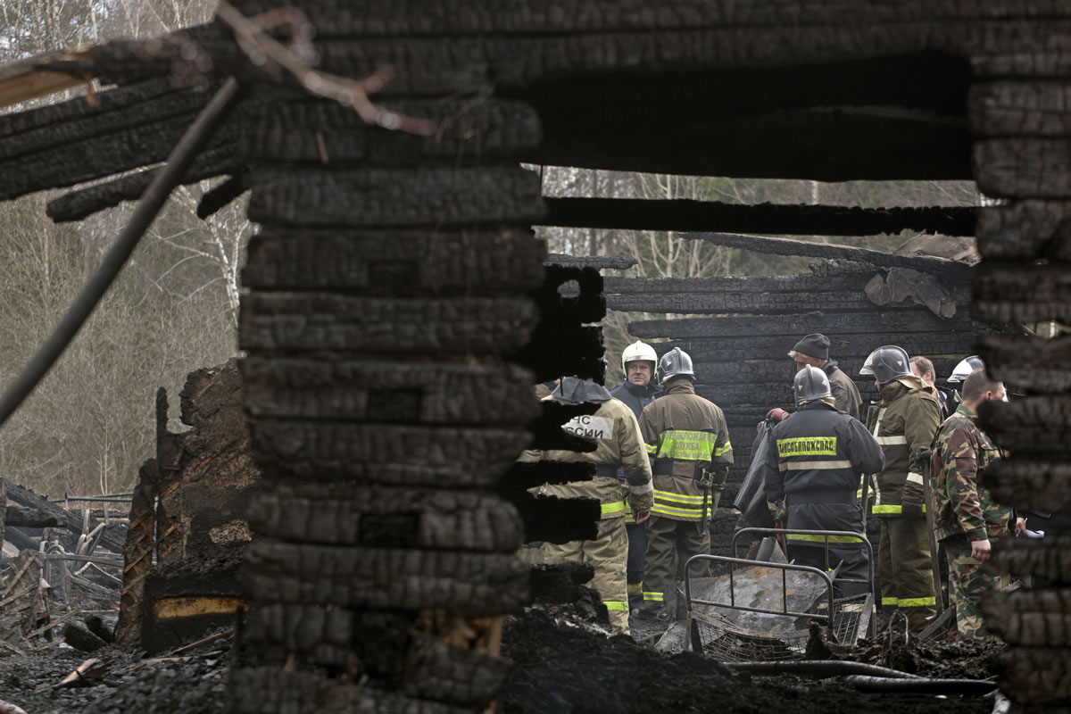 Ministry for Emergency Situations workers and firefighters work at the site of a fire at a psychiatric hospital Friday morning. A fire raged through a psychiatric hospital outside Moscow early Friday, killing 38 people, including two nurses, emergency officials said. Police said the fire, which broke out at about 2 a.m.