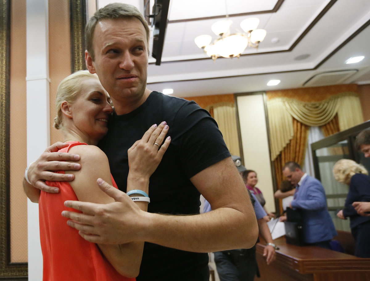 Russian opposition leader Alexei Navalny, right, embraces his wife, Yulia.