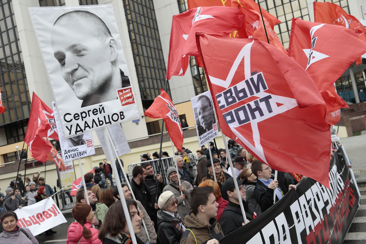 Members of opposition group Left Front carry flags and a portrait ofopposition leader Sergei Udaltsov as they take part in an opposition rally in downtown Moscow on Sunday.