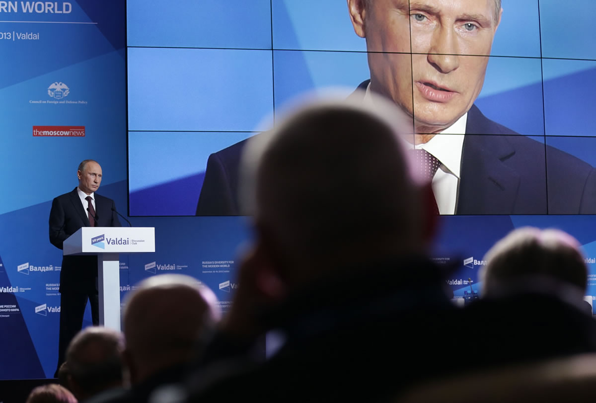 Russian President Vladimir Putin, left, speaks during the final plenary meeting of the Valdai International Discussion Club in the Novgorod Region on the banks of Lake Valdai, Russia, on Thursday.