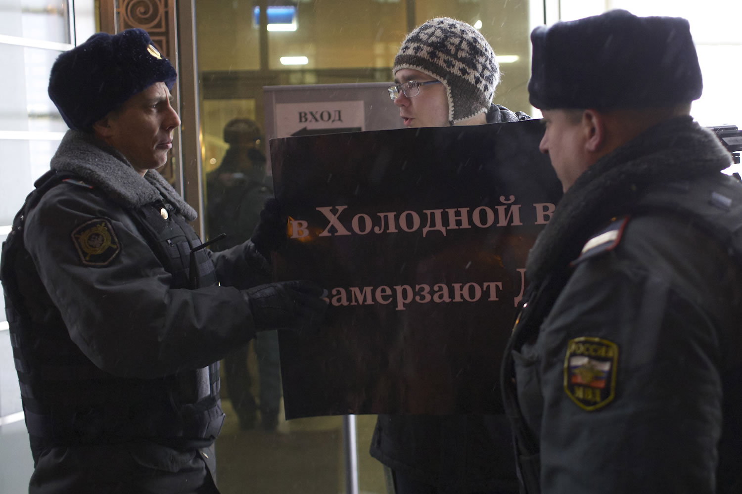 A protester argues with police officers outside the Federation Council on Wednesday. Several protesters were detained Wednesday morning outside the upper chamber of Russia's parliament as it prepared to vote on a controversial measure banning Americans from adopting Russian children.