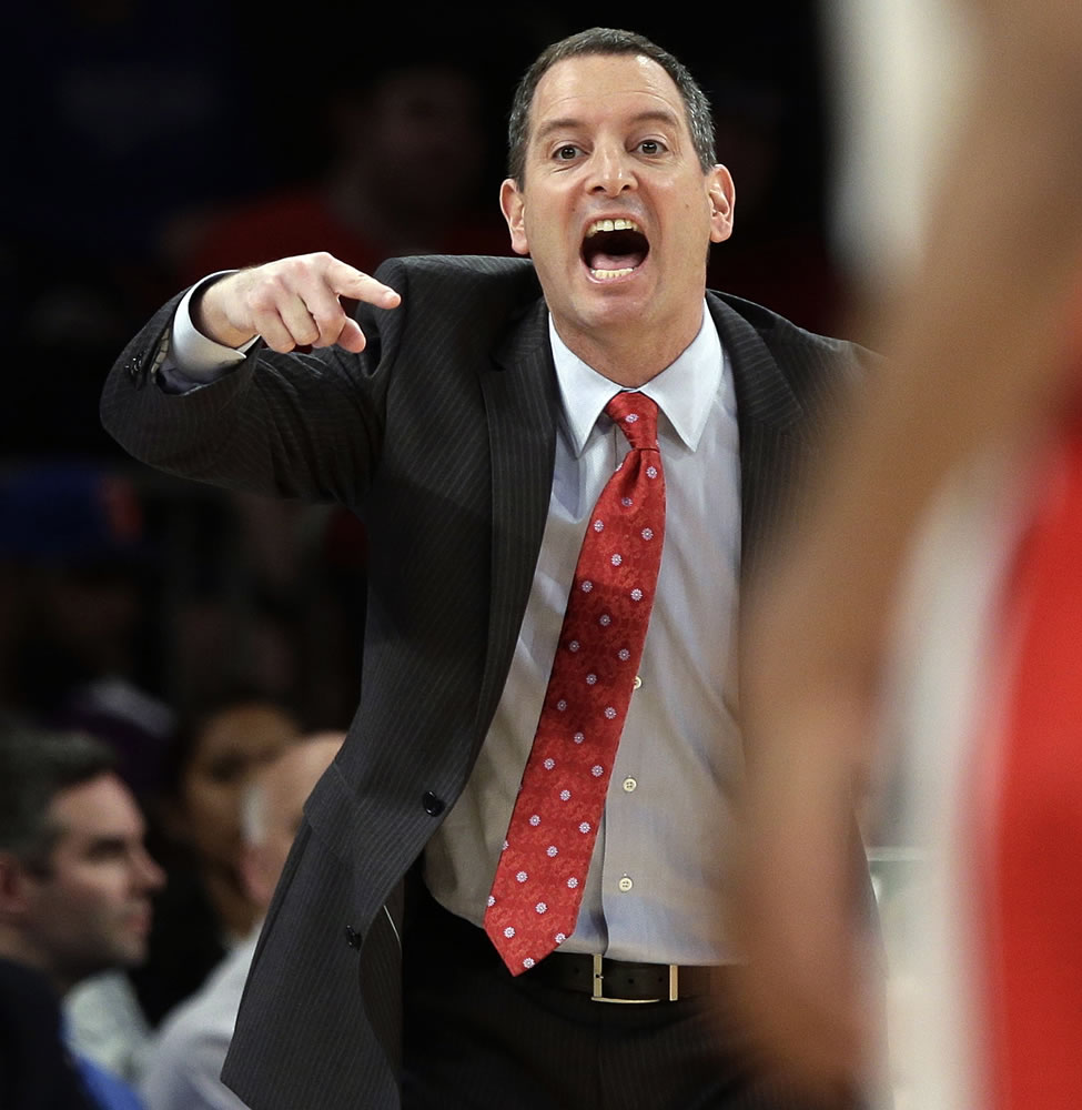 In this March 12, 2013, file photo, Rutgers coach Mike Rice yells out to his team during an NCAA college basketball game against DePaul at the Big East tournament in New York. Rutgers said it would reconsider its decision to retain Rice after a videotape aired showing him shoving, grabbing and throwing balls at players in practice and using gay slurs. The videotape, broadcast Tuesday, April 2, on ESPN, prompted scores of outraged social media comments as well as sharp criticism from Gov.
