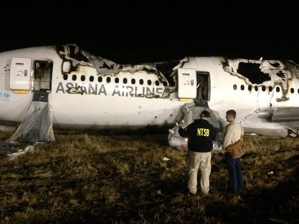 NTSB investigators conduct a first site assessment overnight of the Asiana Airlines flight 214 that crashed at the San Francisco International Airport in San Francisco, Saturday. The Asiana Airlines Boeing 777 crashed while landing after a likely 10-hour-plus flight from Seoul, South Korea.
