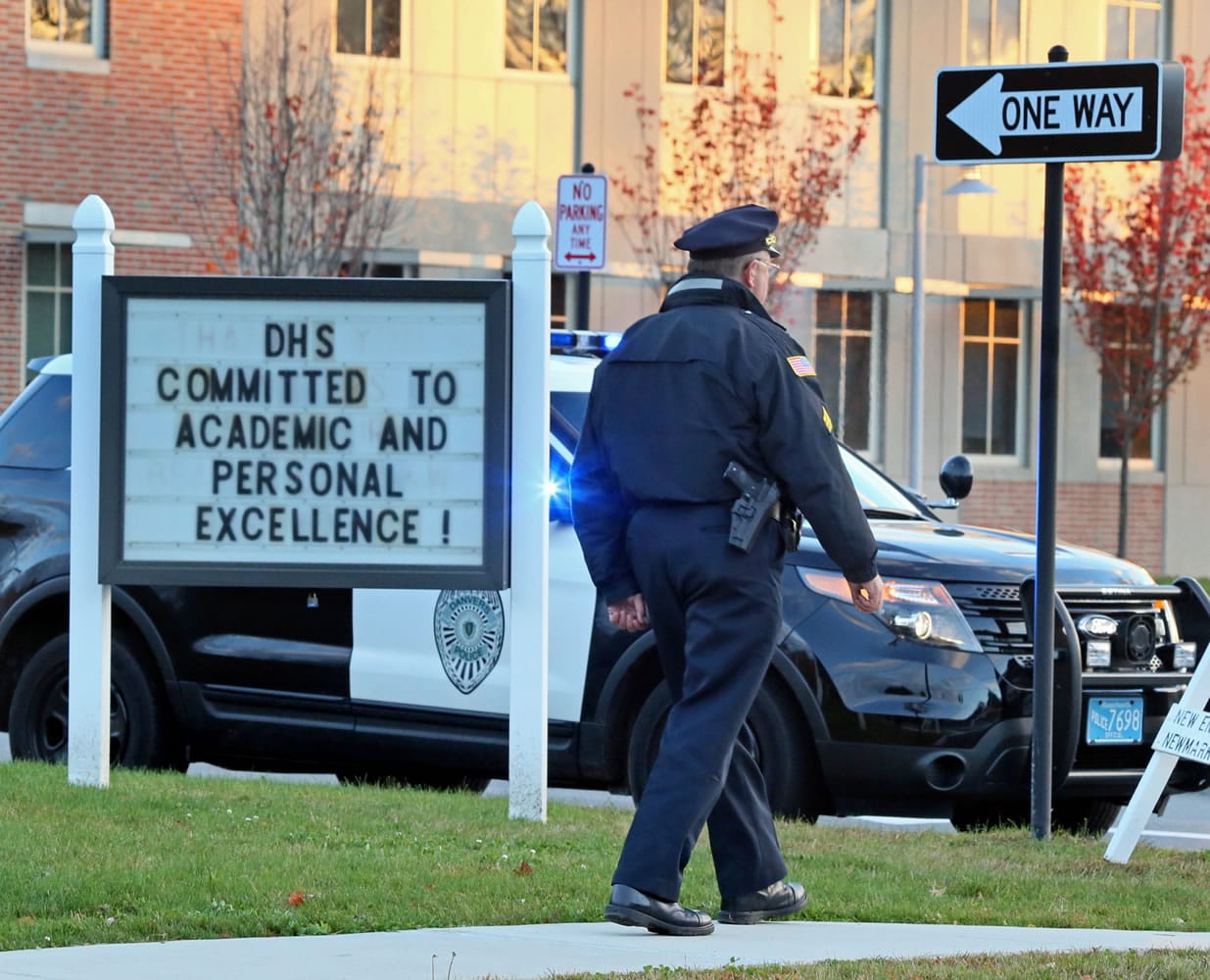 Danvers police are seen Wednesday at the Danvers High School, investigating a report of a sudden death inside the school in Danvers, Mass.