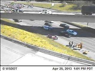 A Washington State Department of Transportation traffic camera at Interstate 5 at state Highway 14 captured this image of what appears to be paramedics helping a motorcyclist believed to have gone over the Highway 14 overpass and landed on I-5 just before 1 p.m.