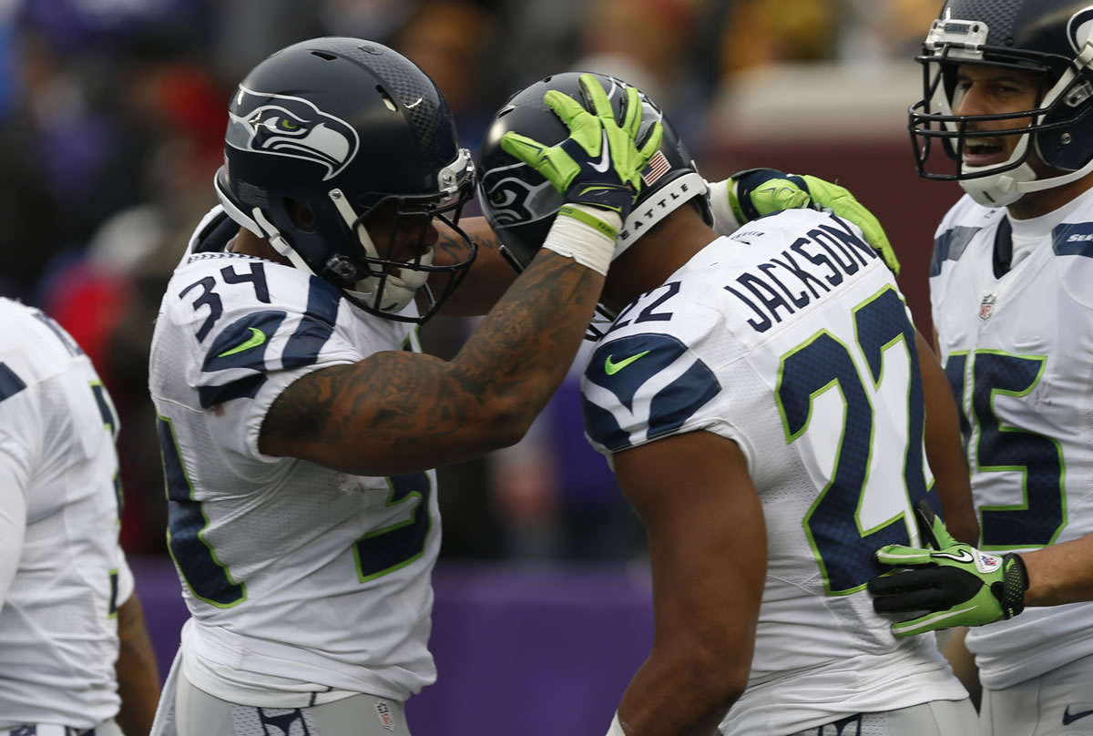 Seattle Seahawks running back Fred Jackson (22) celebrates his five-yard touchdown reception with Thomas Rawls (34) in the second half of an NFL football game against the Minnesota Vikings, Sunday, Dec. 6, 2015 in Minneapolis.