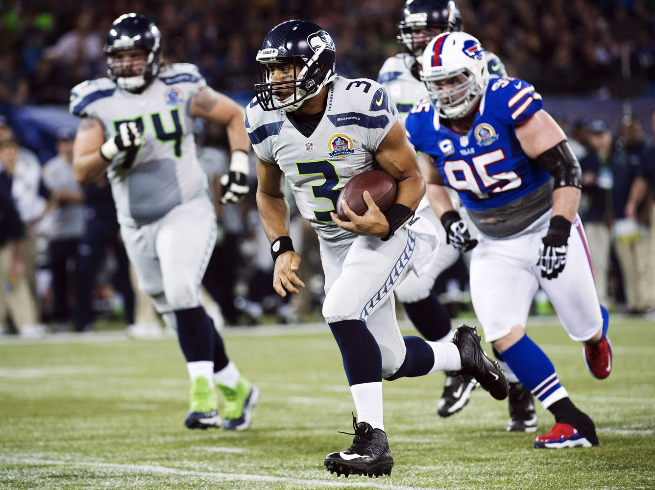 Seattle Seahawks quarterback Russell Wilson (3) runs for a touchdown ahead of Buffalo Bills defensive tackle Kyle Williams (95) during the first the half in Toronto on Sunday.