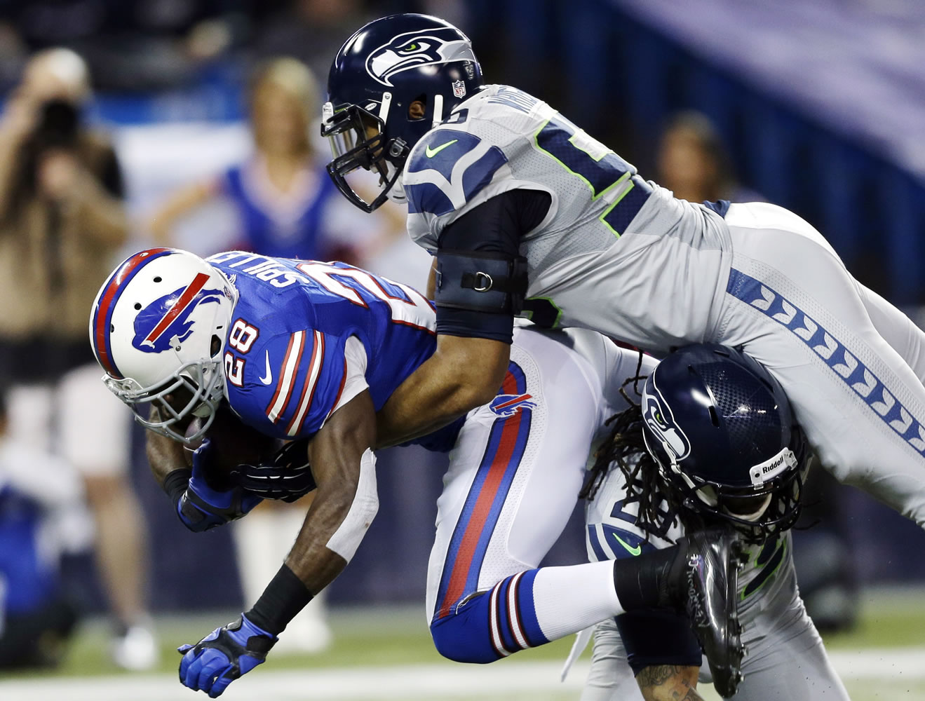 Buffalo Bills running back C.J. Spiller (28) is tackled by Seattle Seahawks free safety Earl Thomas (29) and outside linebacker K.J.