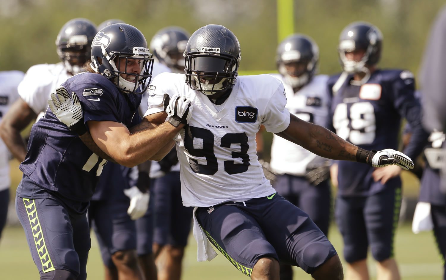 Seattle Seahawks' Brett Swain, left, shoves against O'Brien Schofield during NFL football training camp Tuesday, July 30, 2013, in Renton, Wash.