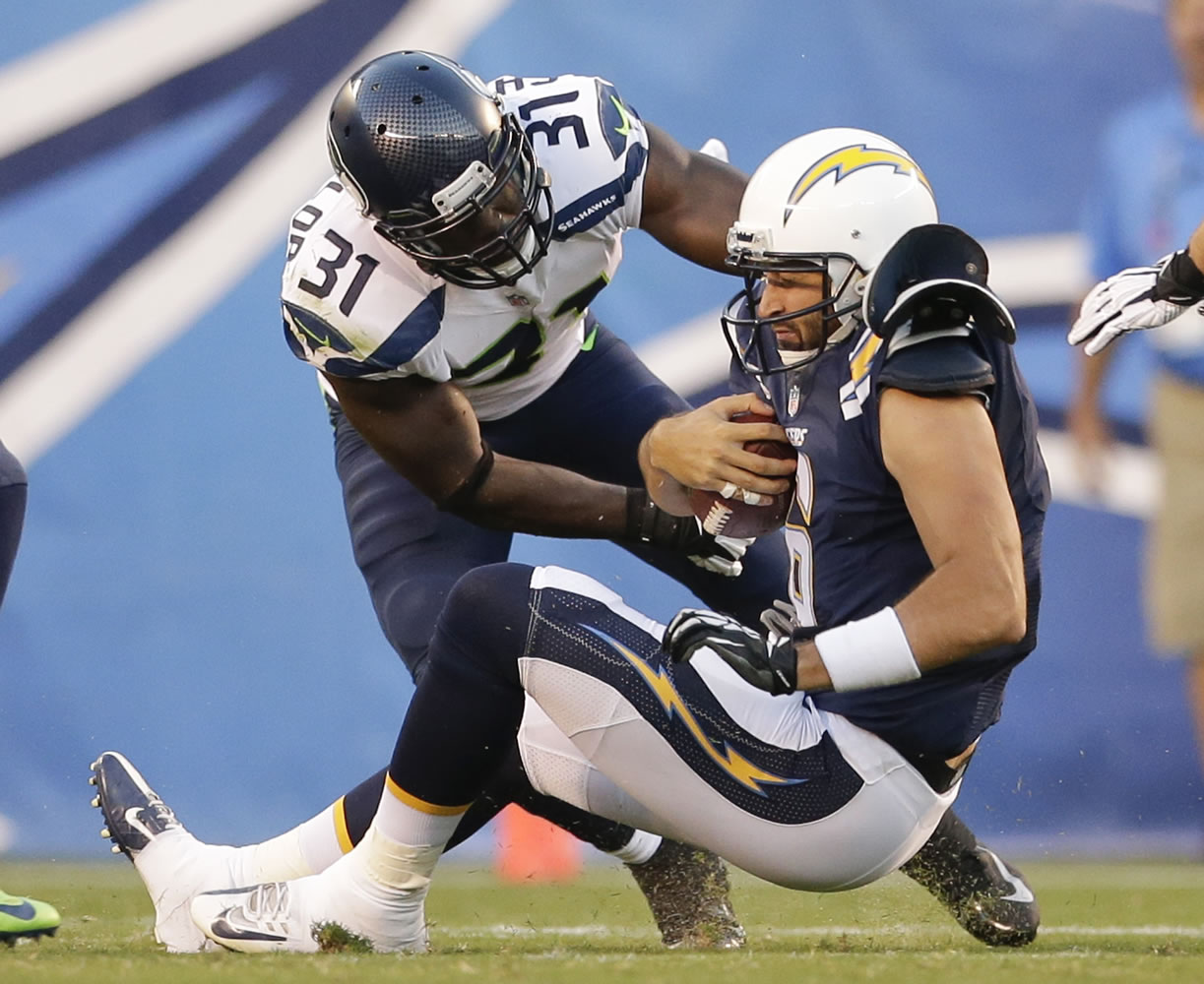 San Diego Chargers quarterback Charlie Whitehurst is sacked by Seattle Seahawks strong safety Kam Chancellor in the second quarter Thursday.