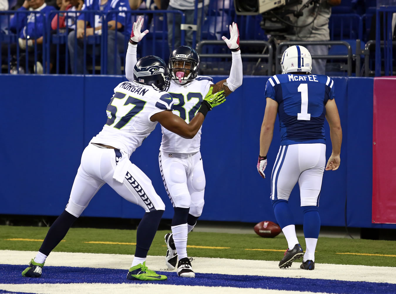 Seattle linebacker Mike Morgan (57) and safety Jeron Johnson celebrate a safety in front of Indianapolis Colts punter Pat McAfee during the first quarter Sunday.