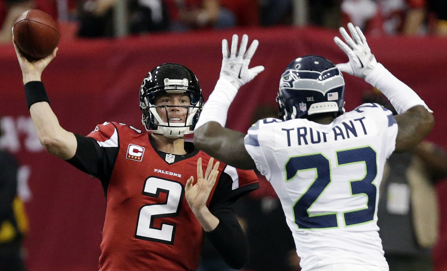 Atlanta Falcons quarterback Matt Ryan (2) throws as Seattle Seahawks cornerback Marcus Trufant (23) tries to make the stop during the second half Sunday.