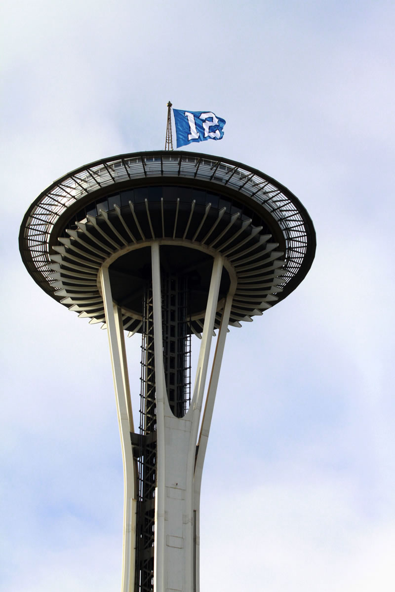 The 12th Man flag flies atop Seattle's Space Needle on Friday honoring the playoff-bound Seattle Seahawks.