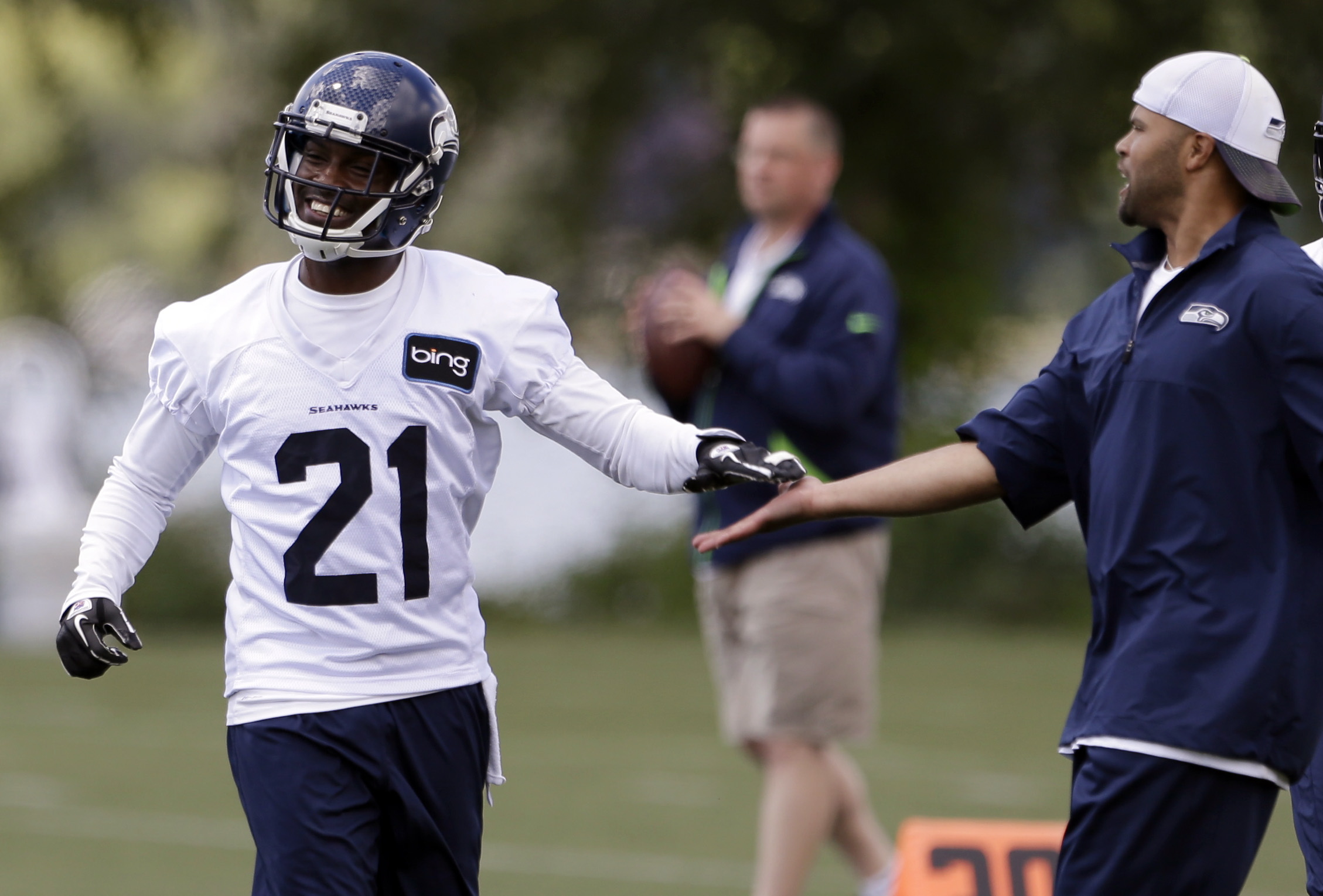 Seattle Seahawks' Antoine Winfield (21) is congratulated by secondary coach Kris Richard after a turn at scrimmage during an NFL football minicamp on Wednesday, June 12, 2013, in Renton, Wash (AP Photo/Elaine Thompson)