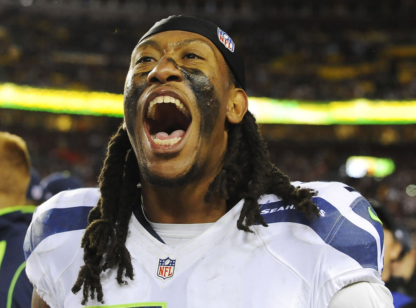 Seattle Seahawks defensive end Bruce Irvin celebrates his team's victory on the sidelines Sunday.