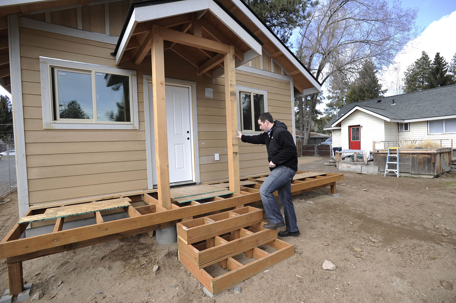 Ryan Davies walks into his accessory dwelling unit behind his home in Bend, Ore., on Thursday.