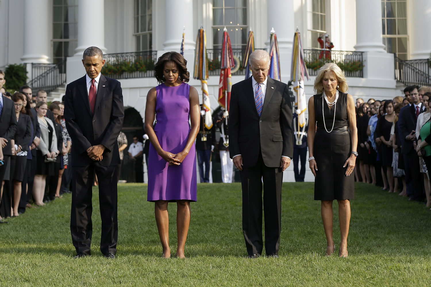 President Barack Obama, first lady Michelle Obama, Vice President Joe Biden and Jill Biden bow their heads for a moment of silence on the South Lawn of the White House in Washington on Wednesday to mark the 12th anniversary of the September 11 terror attacks.