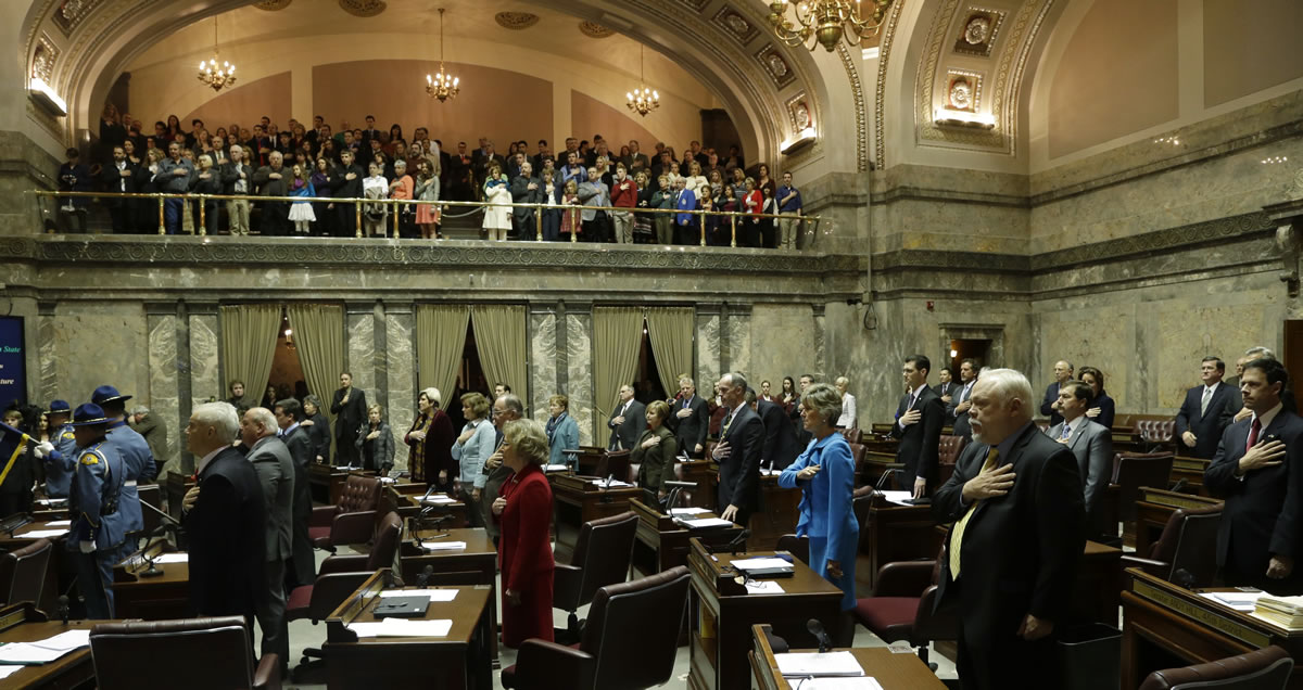 Senators and visitors in the gallery recite the Pledge of Allegiance on the Senate floor  Monday at the Capitol in Olympia on the first day of the 2013 legislative session. In the foreground at right is Sen.