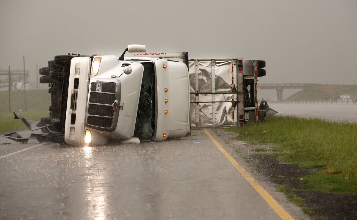 Overturned trucks block a frontage road off I-40 just east of 81 in El Reno, Okla., after a tornado moved through the area on Friday.