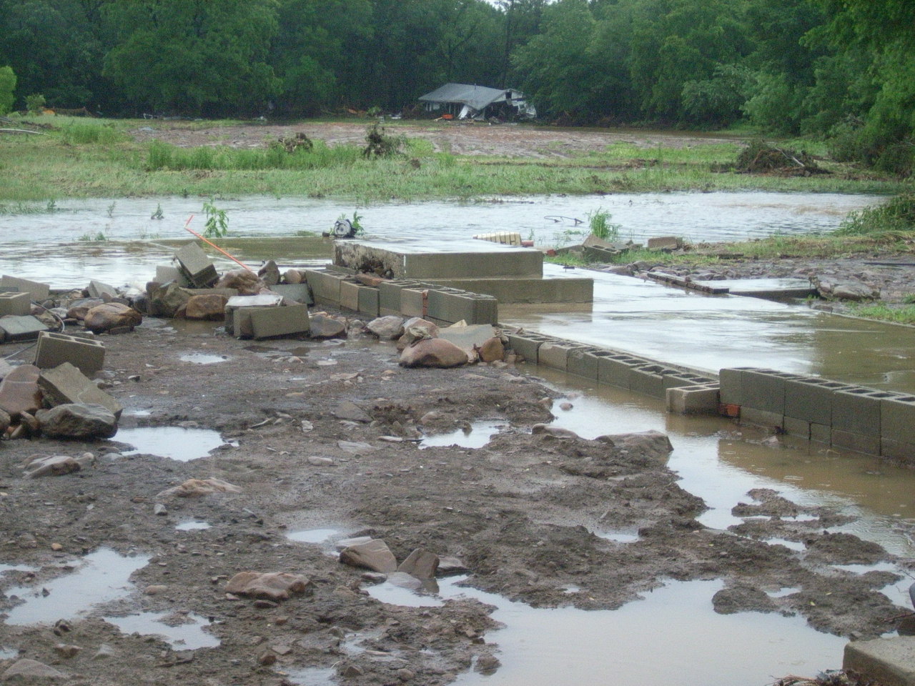 The foundation of a house, foreground, that Brushy Creek washed away in Montgomery County between Oden and Mount Ida, Ark.