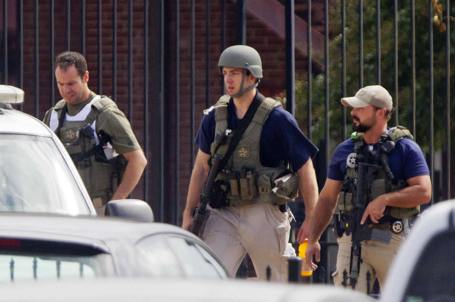 Armed U.S. Marshals leave the scene where a gunman was reported at the Washington Navy Yard in Washington, on Monday.
