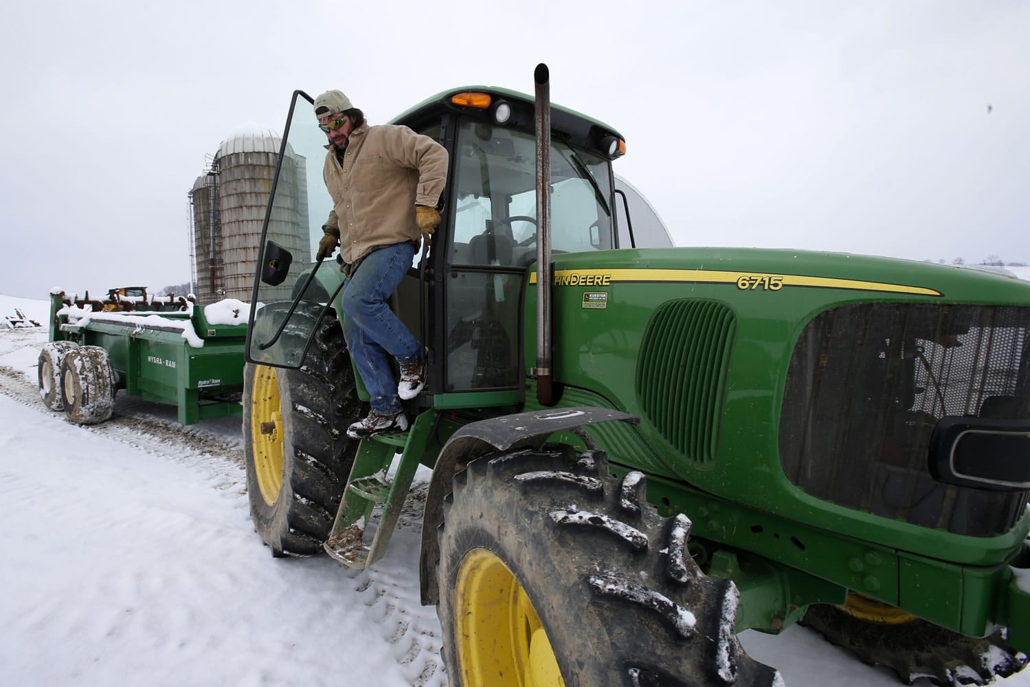 Shawn Georgetti climbs out of his John Deere tractor on his 167-acre family dairy farm in Avella, Pa., in January 2013  Small businesses are close to getting a permanent half-million-dollar tax break when they buy equipment like cars, computers and machinery.
