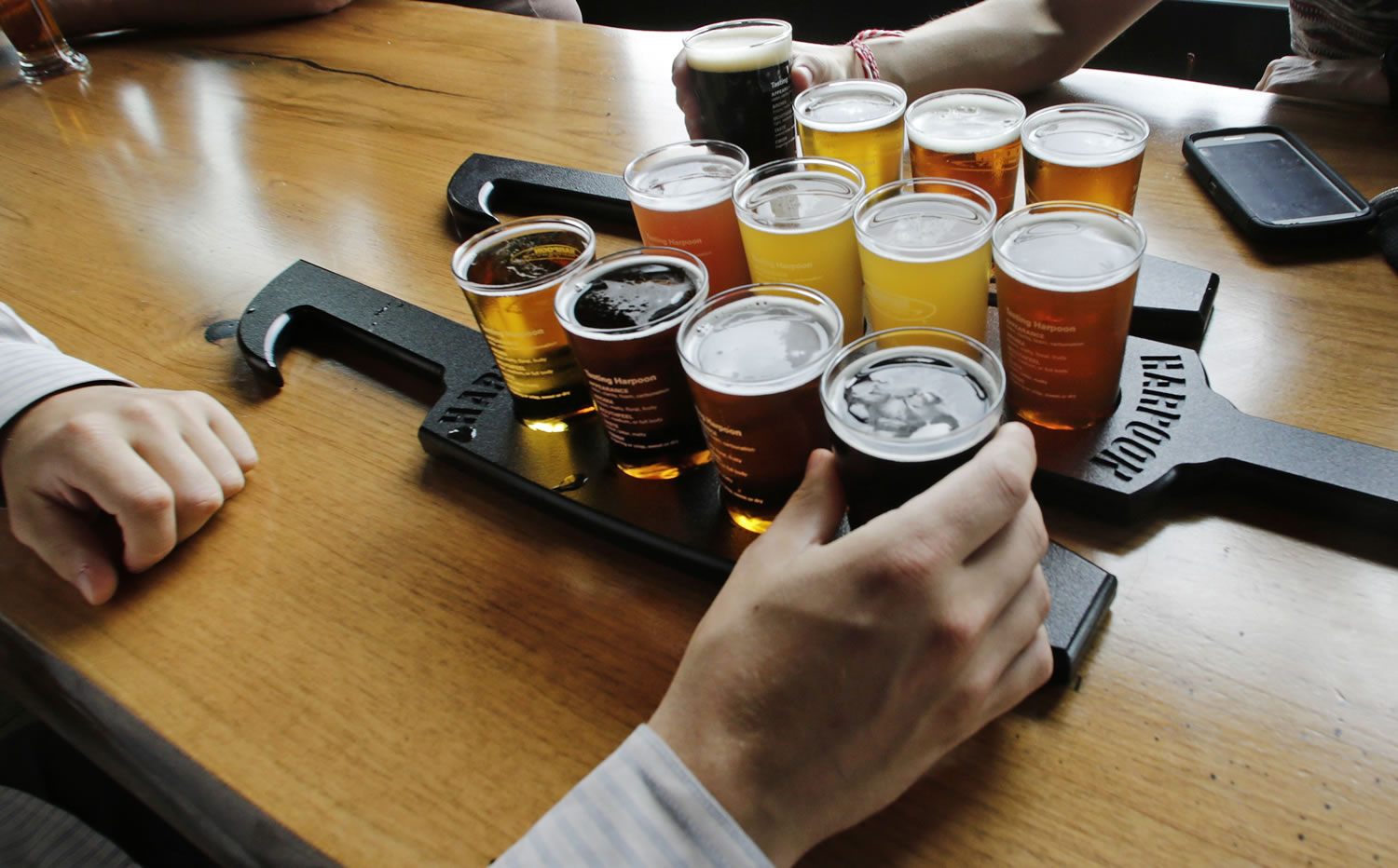 A couple taste a selection of 12 different beer flights at the Beer Hall at the Harpoon Brewery in Boston.
