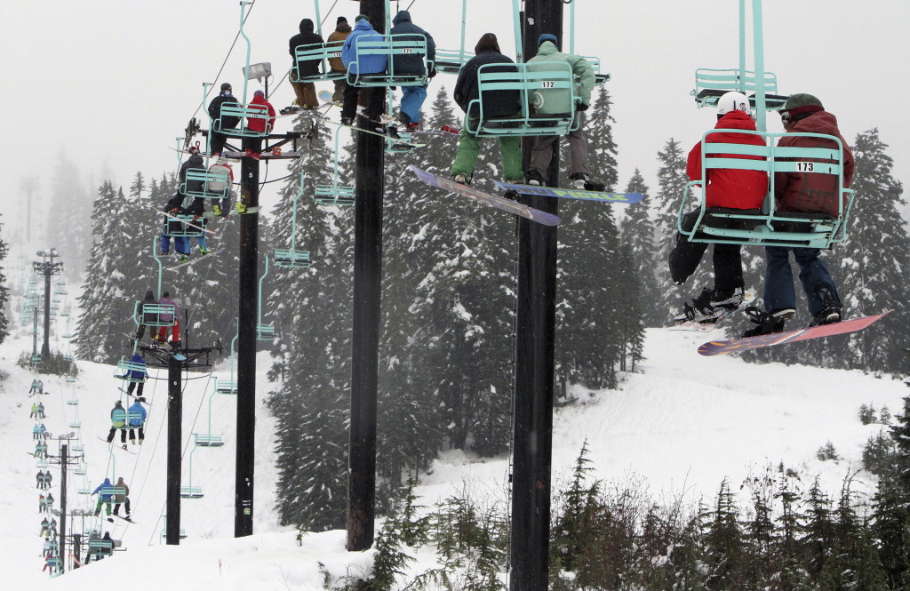 Skiers and snowboarders ride a chairlift at Stevens Pass, Wash.  on Nov. 20 2013.