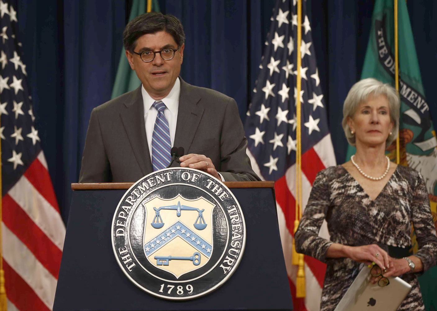 Treasury Secretary Jacob Lew, accompanied by Health and Human Services Secretary Kathleen Sebelius, speaks about Social Security and Medicare on Friday at the Treasury Department in Washington. The government says Medicare's giant hospital trust will not be exhausted until 2026, while the date that Social Security will exhaust its trust fund is unchanged at 2033.