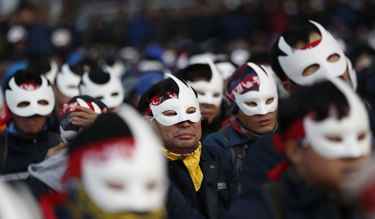Masked protesters attend an anti-government rally Saturday in downtown Seoul, South Korea.