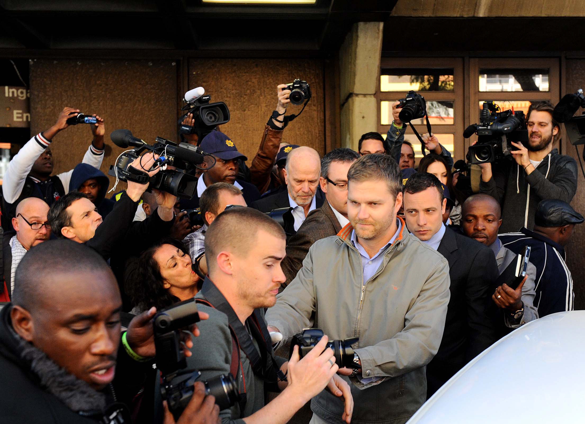 Oscar Pistorius, third from right, leaves the magistrates court in Pretoria, South Africa, on Tuesday. Pistorius is accused of the shooting death of his girlfriend, Reeva Steenkamp, on Feb.