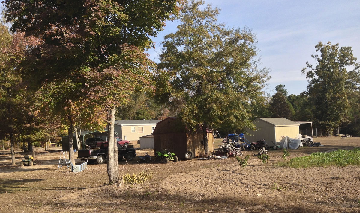 The backyard of a home where six people were found dead on Tuesday is seen Wednesday in rural Greenwood, S.C.