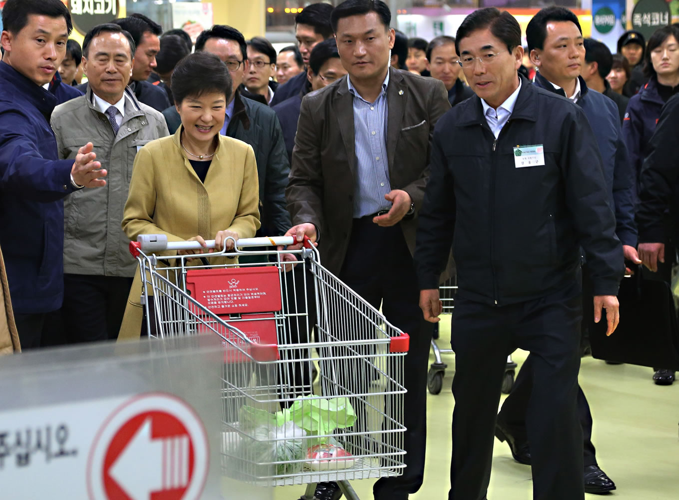 South Korean President Park Geun-hye, third from left, pushes a cart to a counter to pay for her purchases at a retail store in Seoul, South Korea, on Wednesday.