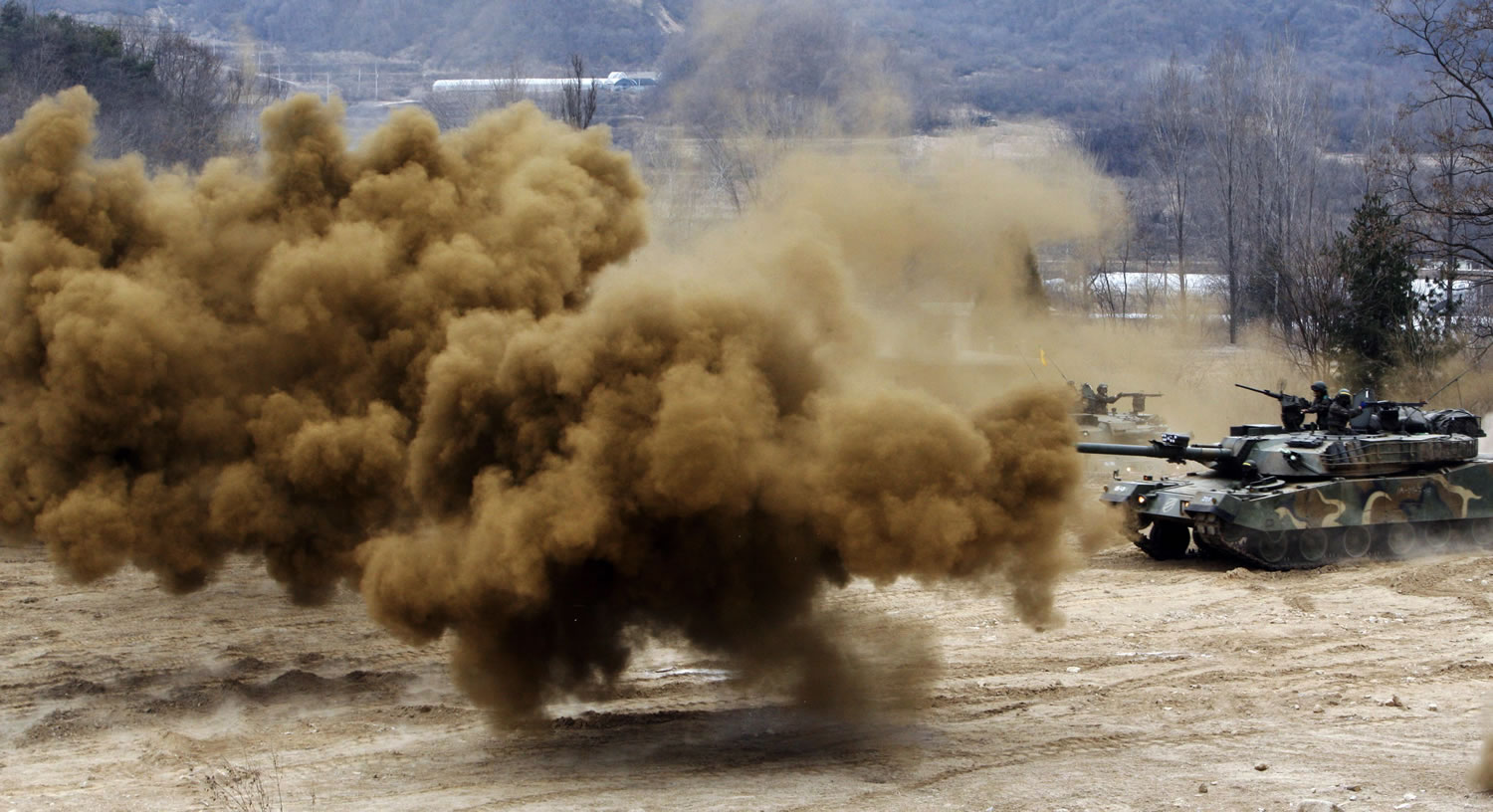 Smoke bombs explode near South Korean army tanks during an exercise against possible attacks by North Korea near the demilitarized zone in Hwacheon, South Korea, on Monday.